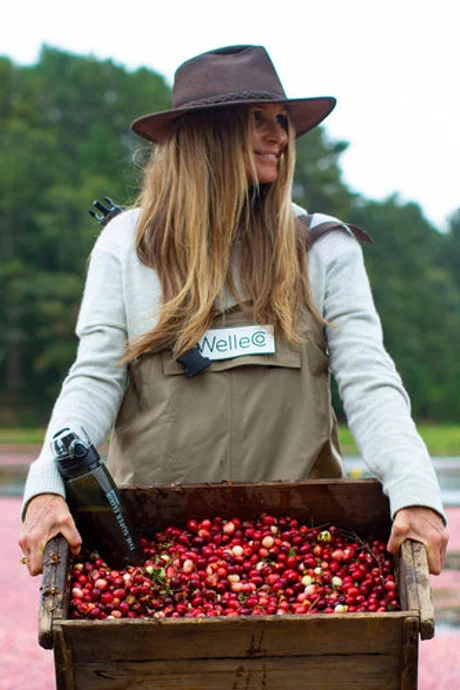 WelleCo founder Elle Macpherson harvesting colourful cranberries